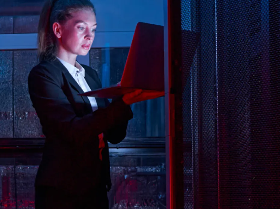 Engineer with a laptop in a data centre