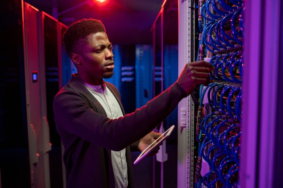 Engineer checking a patch panel with a tablet
