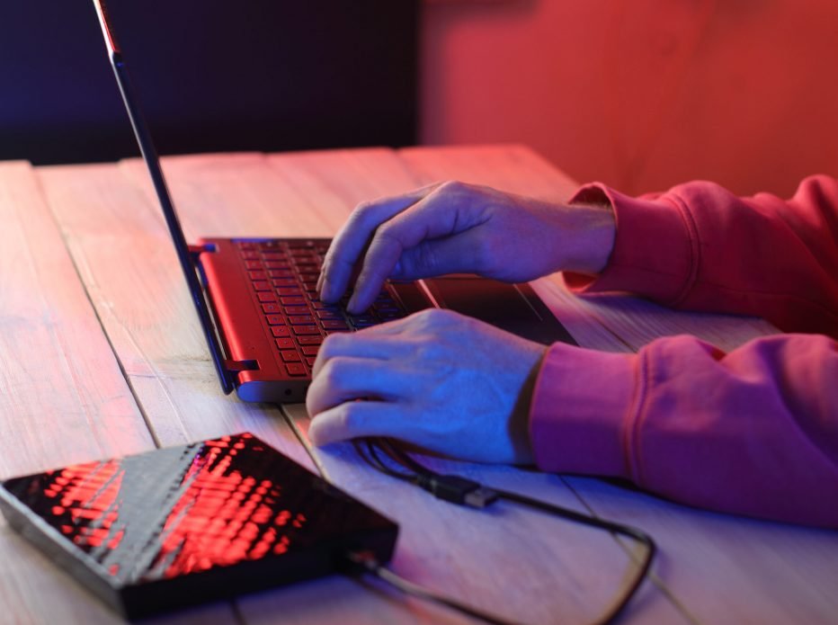 Hands typing on a laptop