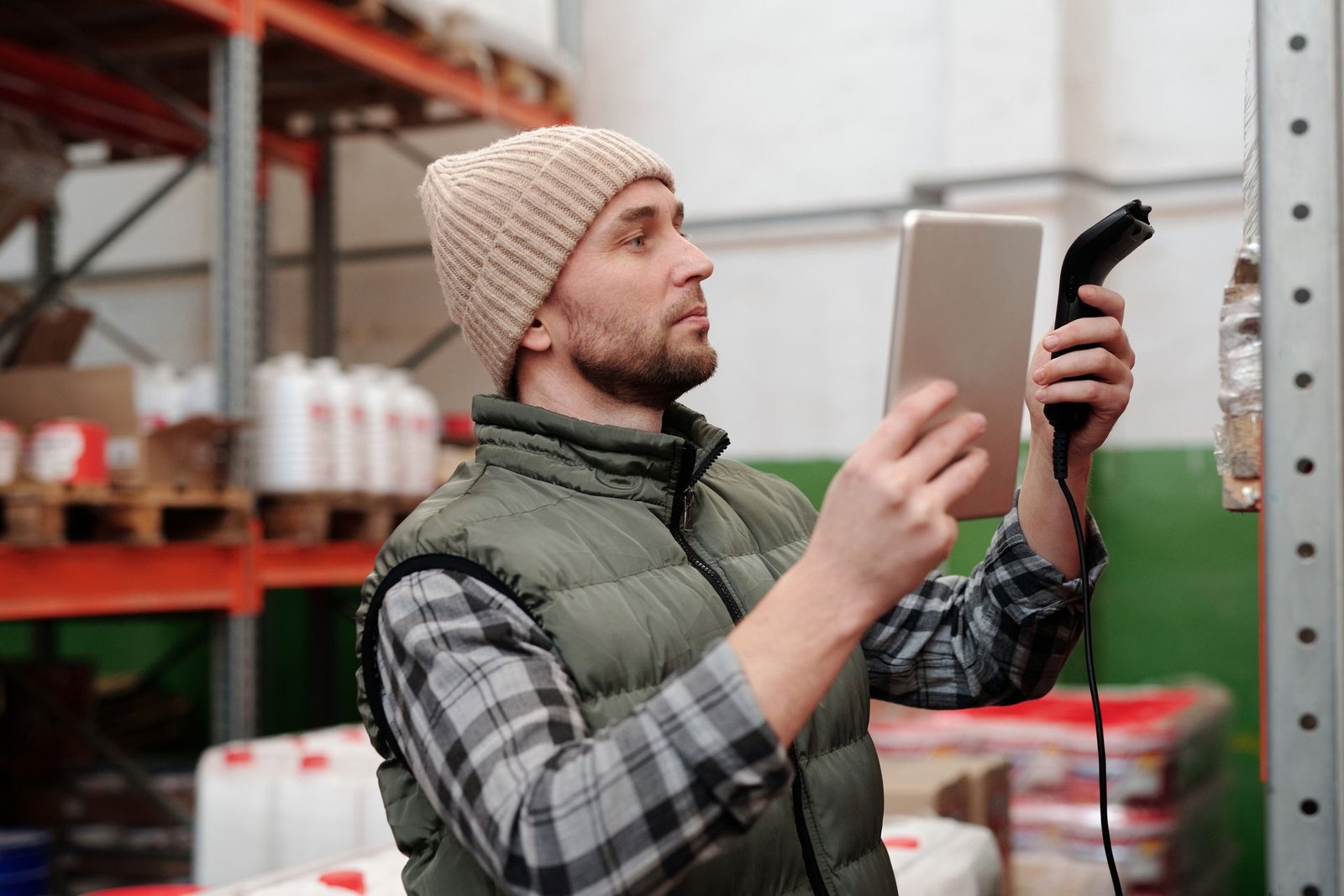 Technician using a tablet and scanner in a warehouse